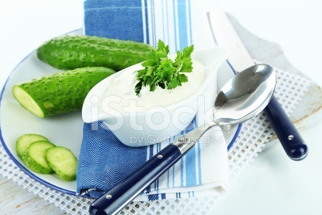 54651664-cucumber-yogurt-in-sauceboat-on-color-napkin-isolated-on-white.jpg